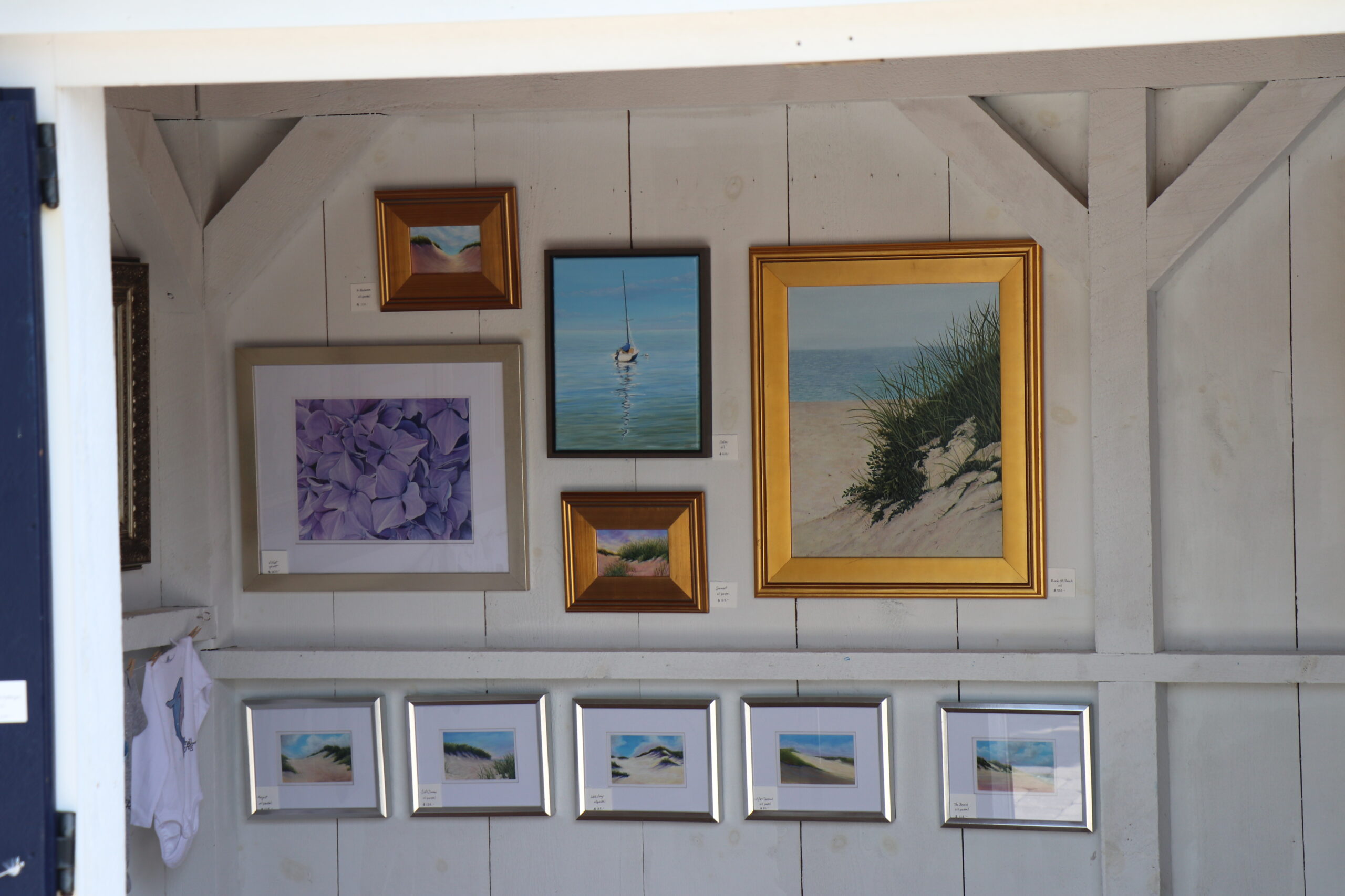 Framed paintings and pictures on the wall of a house