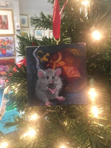 A painting of a mouse hanging on a christmas tree.
