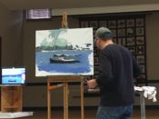 A man painting a boat on an easel.