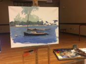 A painting of a sailboat on a easel.