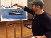 A man painting a boat on an easel.