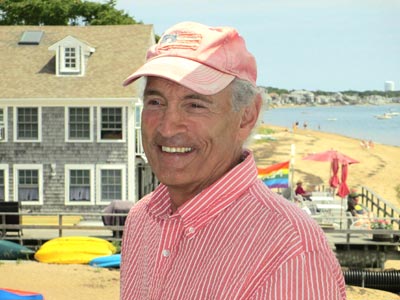 A man wearing a red hat on the beach.