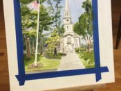 A painting of a church on an easel.