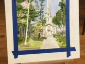 A painting of a church and flag on a easel.