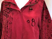 A red jacket with black writing on it.