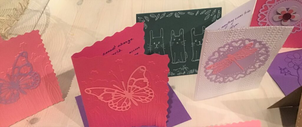 A variety of cards with butterflies and flowers on them.