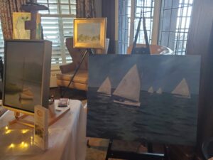 A painting of sailboats on a table.