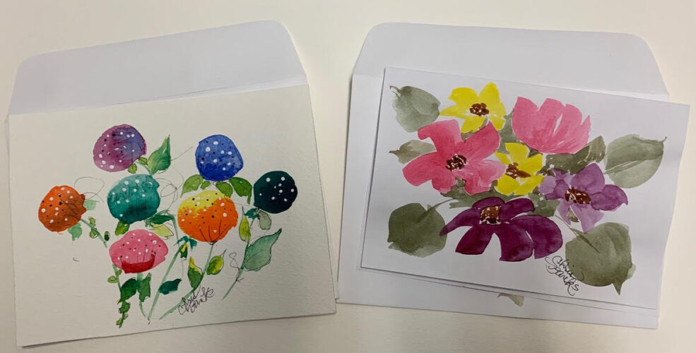 A couple of envelopes with flowers on them.