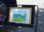 A framed painting on a stand.