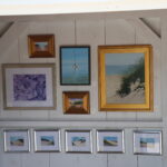 Framed paintings and pictures on the wall of a house