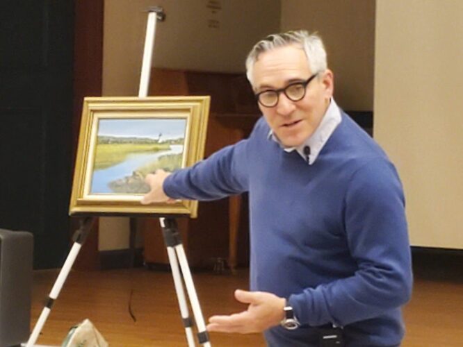 A man standing in front of a painting in front of a easel.