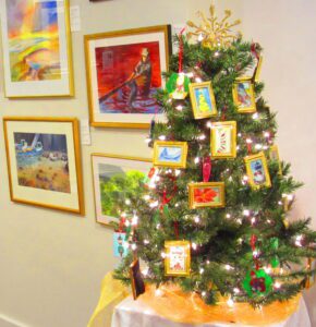 Christmas tree with framed artwork ornaments.